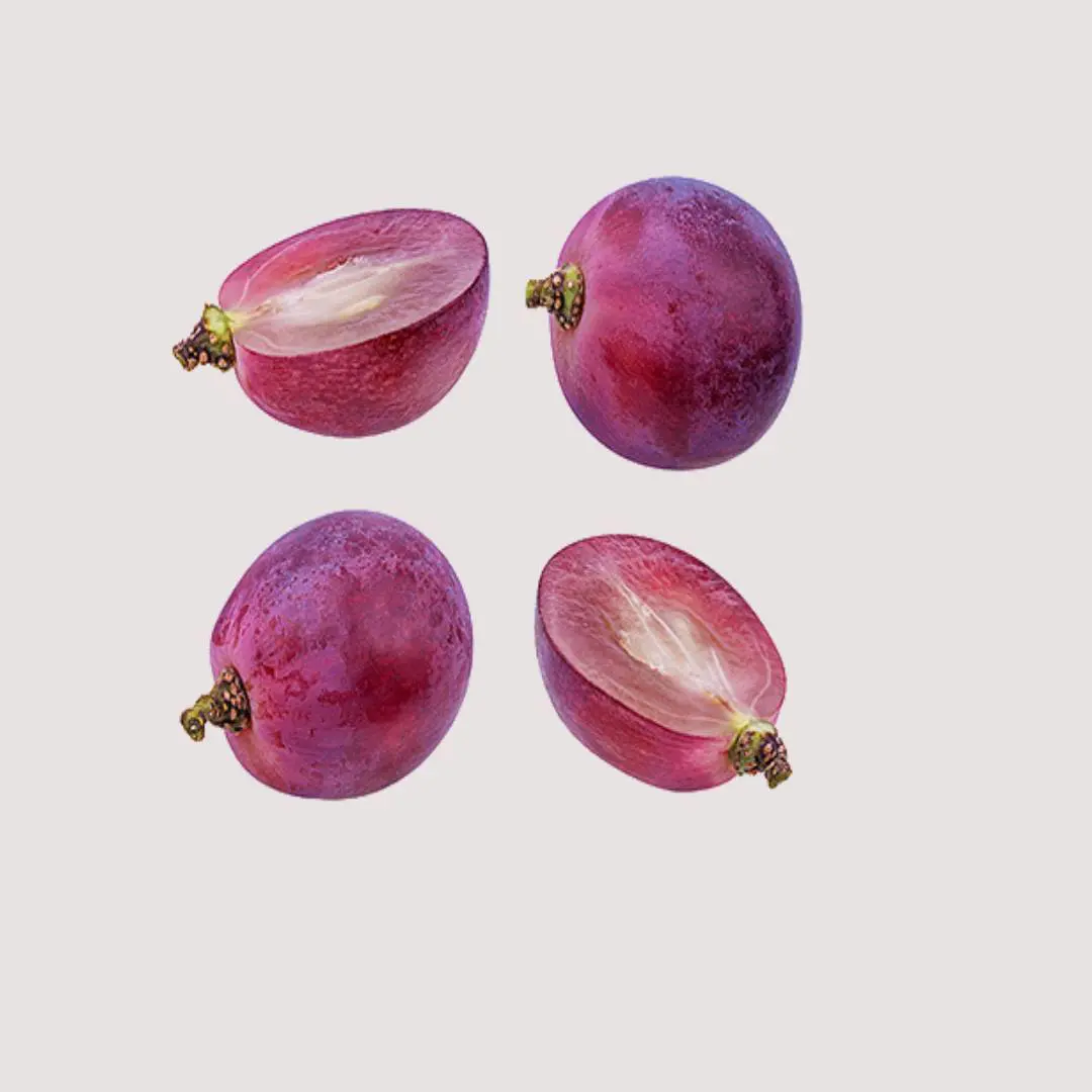 Four purple grapes are shown with one cut in half.